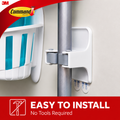 Damage-Free Broom Holder installed on a wall, showcasing tool-free mounting, perfect for organizing brooms.