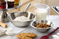 Heavy-duty stainless steel mixing bowl 13 quart with flour, measuring cup, and cookie dough on a kitchen countertop.